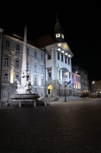 Za řekou vstupujeme na Městské náměstí (Mestni trg), kde zaujme například radnice a Robbova fontána (Robbov vodnjak), tedy přesněji její kopie, originál mají Slovinci schovaný v národní galerii.