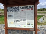 Bývalá farní obec Zhůří měla ještě v roce 1946 spolu s přilehlými osadami 1100 obyvatel. Tyto osady však musely ustoupit vojenskému prostoru a byly do roku 1957 zbořeny a odstraněny. Zůstaly jen meandry říčky Křemelné v údolí Zde se odehrál jeden z posledních bojů na konci II. světové války. V prostoru od Železné Rudy, směrem do vnitrozemí, kde byla situace nejtěžší, připravoval bezproblémovou cestu 4. obrněné divizi při její cestě na Prahu 357. pluk 90. pěší divize společně s 2. jízdní průzkumnou skupinou XII. sboru. Ve směru na Hartmanice kladli Američanům poslední houževnatý odpor také němečtí důstojničtí kadeti Školy praporečníků, kteří obsadili Prášily a Srní. Dne 4. května mladí nacisté přepadli četu jízdního průzkumu a ukořistili Američanům dva kolové obrněnce M8 a čtyři jeepy. Brzy ráno 5. května vyrazili za hustého deště vojáci 90. pěší na průzkum směrem do vnitrozemí, kde byla v té době ještě nejasná situace. Úkol byl jasný: zajistit hlavní přístupové cesty a prohledat tamní samoty a německé vesnice. Právě ve Zhůří, kam se jako první přiblížila rota „I“, postavili na náves mladí němečtí vojáci vozidla M8 a jeepy ukořistěné předchozího dne. Američtí vojáci postupující od Starého Brunstu mysleli, že jsou v poloprázdném Zhůří ověšeném bílými prapory jejich kolegové z průzkumné kavalerie, vyrazili bez obav vpřed. Překvapila je však střelba z jejich vlastních zbraní a deset Američanů tu na samém konci války padlo. Roztrpčení pěšáci, vědomi si léčky, do které padli, ani nepožádali o dělostřeleckou podporu a v krátké době zahájili protiútok. Došlo k tvrdému boji muže proti muži, bojovalo se téměř o každý dům, sedm stavení zcela vyhořelo a o střechu přišel i kostel Nejsvětější Trojice. 24 německých důstojnických kadetů a příslušníků Hitlerjugend v boji přišlo o život, 76 bylo zajato. Na straně Američanů bylo kromě 10 mrtvých dalších 17 zraněných. V červenci 2000 byl na Zhůří odhalen žulový pomník se jmény padlých vojáků. Je to poslední z řady pomníků americké armádě v západních Čechách, avšak první věnovaný 90. pěší divizi 3. armády. (Použita část textu u pomníku). (mapy.com)
