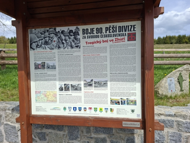 Bývalá farní obec Zhůří měla ještě v roce 1946 spolu s přilehlými osadami 1100 obyvatel. Tyto osady však musely ustoupit vojenskému prostoru a byly do roku 1957 zbořeny a odstraněny. Zůstaly jen meandry říčky Křemelné v údolí Zde se odehrál jeden z posledních bojů na konci II. světové války. V prostoru od Železné Rudy, směrem do vnitrozemí, kde byla situace nejtěžší, připravoval bezproblémovou cestu 4. obrněné divizi při její cestě na Prahu 357. pluk 90. pěší divize společně s 2. jízdní průzkumnou skupinou XII. sboru. Ve směru na Hartmanice kladli Američanům poslední houževnatý odpor také němečtí důstojničtí kadeti Školy praporečníků, kteří obsadili Prášily a Srní. Dne 4. května mladí nacisté přepadli četu jízdního průzkumu a ukořistili Američanům dva kolové obrněnce M8 a čtyři jeepy. Brzy ráno 5. května vyrazili za hustého deště vojáci 90. pěší na průzkum směrem do vnitrozemí, kde byla v té době ještě nejasná situace. Úkol byl jasný: zajistit hlavní přístupové cesty a prohledat tamní samoty a německé vesnice. Právě ve Zhůří, kam se jako první přiblížila rota „I“, postavili na náves mladí němečtí vojáci vozidla M8 a jeepy ukořistěné předchozího dne. Američtí vojáci postupující od Starého Brunstu mysleli, že jsou v poloprázdném Zhůří ověšeném bílými prapory jejich kolegové z průzkumné kavalerie, vyrazili bez obav vpřed. Překvapila je však střelba z jejich vlastních zbraní a deset Američanů tu na samém konci války padlo. Roztrpčení pěšáci, vědomi si léčky, do které padli, ani nepožádali o dělostřeleckou podporu a v krátké době zahájili protiútok. Došlo k tvrdému boji muže proti muži, bojovalo se téměř o každý dům, sedm stavení zcela vyhořelo a o střechu přišel i kostel Nejsvětější Trojice. 24 německých důstojnických kadetů a příslušníků Hitlerjugend v boji přišlo o život, 76 bylo zajato. Na straně Američanů bylo kromě 10 mrtvých dalších 17 zraněných. V červenci 2000 byl na Zhůří odhalen žulový pomník se jmény padlých vojáků. Je to poslední z řady pomníků americké armádě v západních Čechách, avšak první věnovaný 90. pěší divizi 3. armády. (Použita část textu u pomníku). (mapy.com)