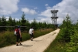 Vzhůru k rozhledně!Když roku 1892 začali pruští turisté stavět na sousedním, o 19 metrů nižším Stohu (Stóg Izerski') rozhlednu, reagovali na to obyvatelé Nového Města pod Smrkem zahájením stavby své vlastní věže na vrcholu Smrku. Ta byla otevřena 21. srpna 1892, tedy jen o měsíc později než konkurenční stavba. Mezi jejími staviteli byl i novoměstský tesař Franz Fritsch, který zůstal v malé chatce u rozhledny a provozoval zde občerstvení. Díky jeho třicetileté pečlivé údržbě a také díky jeho následovníkům vydržela dřevěná rozhledna až do roku 1946, kdy sousední chata z roku 1924 vyhořela. V tomto roce se tehdejší opatrovníci chaty, rodina Porschova, dobrovolně vysídlila do Německa. Neudržovaná věž postupně chátrala a v šedesátých letech se zřítila.